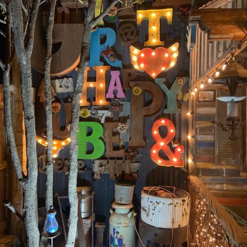 a wall decorated with a combination of letters, numbers and signs creatively arranged into a puzzle of uplifting quotes about love, life and happiness